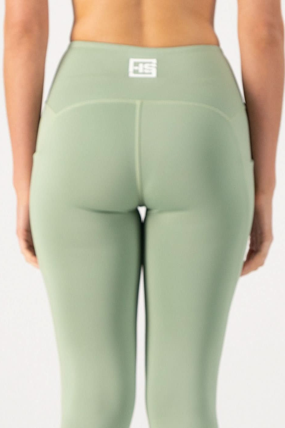 Green leggings with a logo on a white background