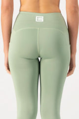 Green leggings with a logo on a white background