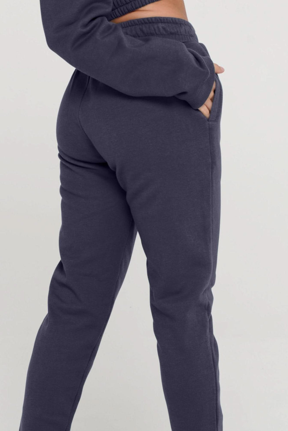 Navy blue jogger pants on a plain background