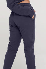 Navy blue jogger pants on a plain background