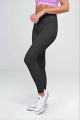 Person wearing black leggings and a purple sports bra on a white background