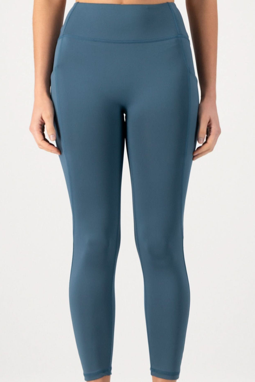 Blue leggings worn by a person on a white background