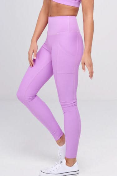 Woman wearing a purple athletic outfit on a white background